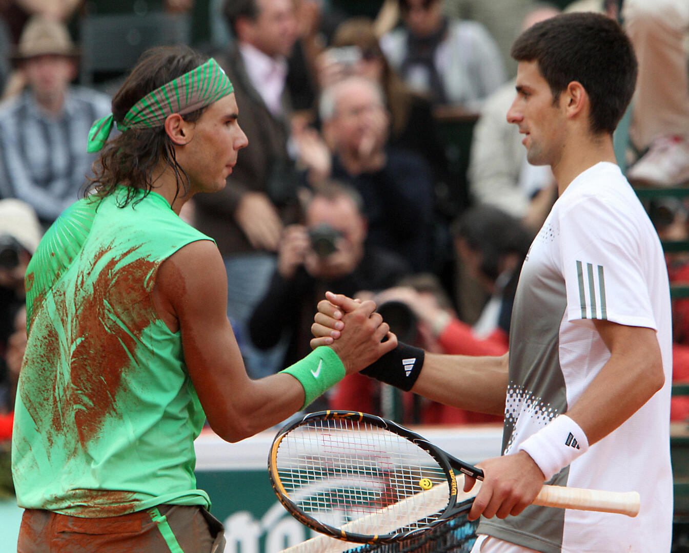 Rafael Nadal and Novak Djokovic shaking hands after a tennis match.
