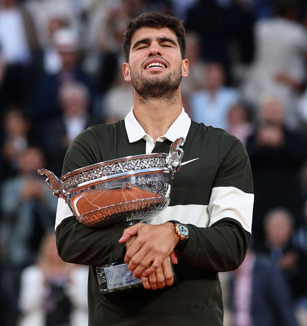 Carlos Alcaraz holding the French Open trophy.